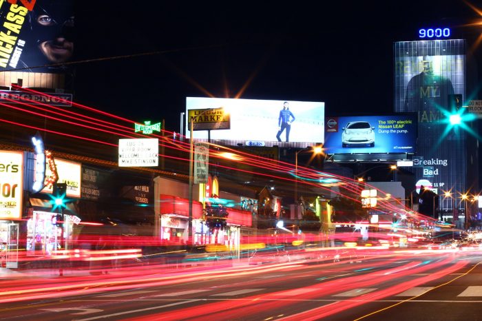 Sunset Strip billboards captured at night with a long exposure of car lights.