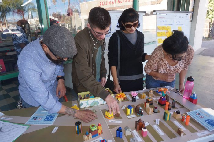 Community members interact with a toy city as part of the South Colton Livable Corridor Plan outreach process