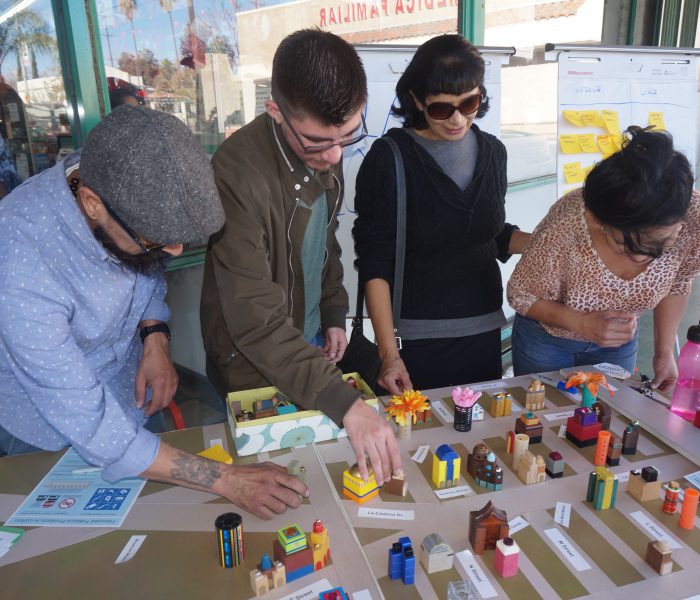 Community members interact with a toy city as part of the South Colton Livable Corridor Plan outreach process