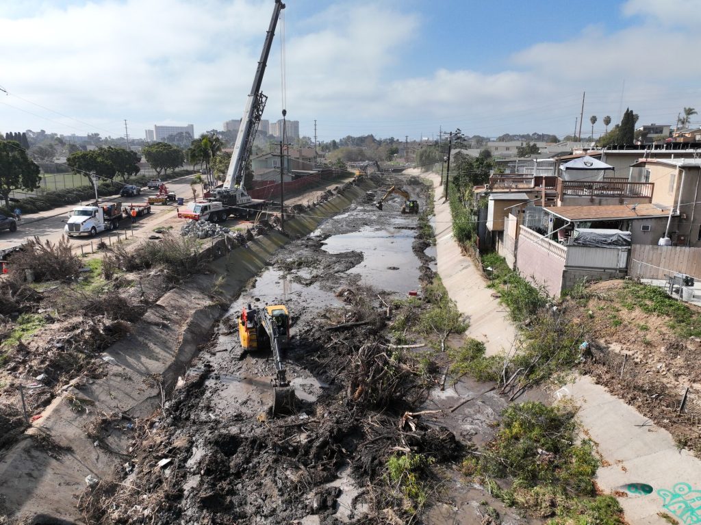 Emergency debris removal and sediment management in a California flood control channel, illustrating storm preparedness, infrastructure maintenance, and emergency permitting activities.